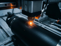 Laser engraver etching a black stainless water bottle
